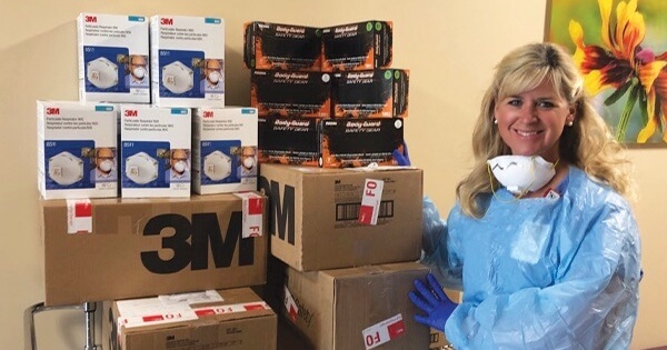 COVID-19 Nurse standing next to medical supply packages