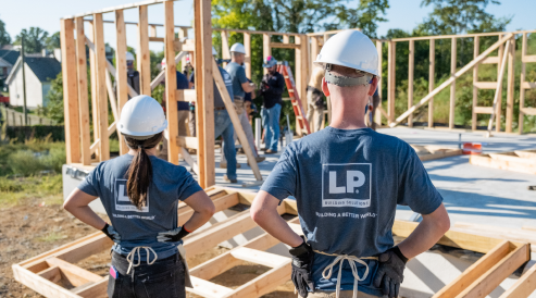 Workers in hard hats on a Habitat for Humanity job site.